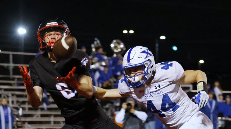 Lakota West's Finn Mason intercepts a pass intended for St. Xavier's Jake Britt during their Division 1 playoff football game Friday, Nov. 15, 2024 at Princeton's Mancuso Field in Sharonville. St. Xavier won 16-13 to advance. NICK GRAHAM/STAFF
