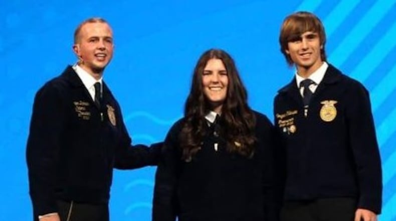 Talawanda FFA Vice President Rachel Dsuban and Treasurer Morgan Gillespie accepted the chapter's National Three Star Award on stage from the National FFA President. CONTRIBUTED