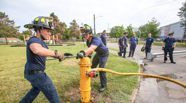 Hamilton firefighters Jon Godby and Mike Lehman, along with three other new hires, work on a hydrant outside of the Pershing Ave. station, Monday, Aug. 14, 2017. The city of Hamilton has started public discussions about its general fund finance budget, which must be approved by the end of the year. 63 cents of every dollar in Hamilton’s proposed general fund for 2018 are to go toward public safety, with 26 cents more going to other major departments. GREG LYNCH/ STAFF
