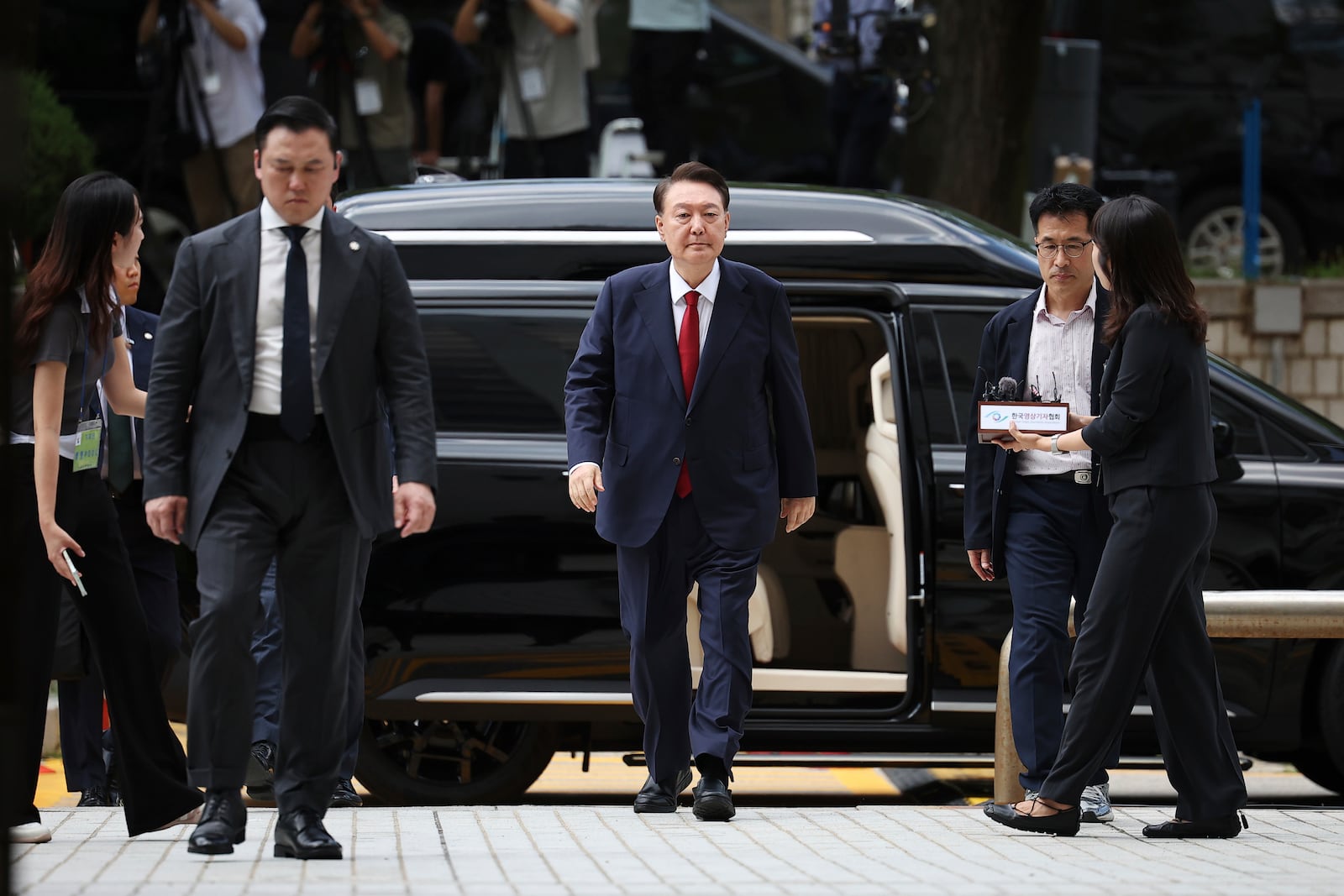 Former South Korean President Yoon Suk Yeol, centerm arrives at a court to attend a hearing to review his arrest warrant requested by special prosecutors in Seoul, South Korea Wednesday, July 9, 2025. (Kim Hong-Ji/Pool Photo via AP)