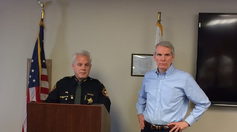 Sheriff Phil Plummer and U.S. Sen. Rob Portman, R-Ohio, discuss the drug crisis after a meeting Monday, Feb. 13, at the Montgomery County Sheriff’s Office. DARIN POPE / STAFF