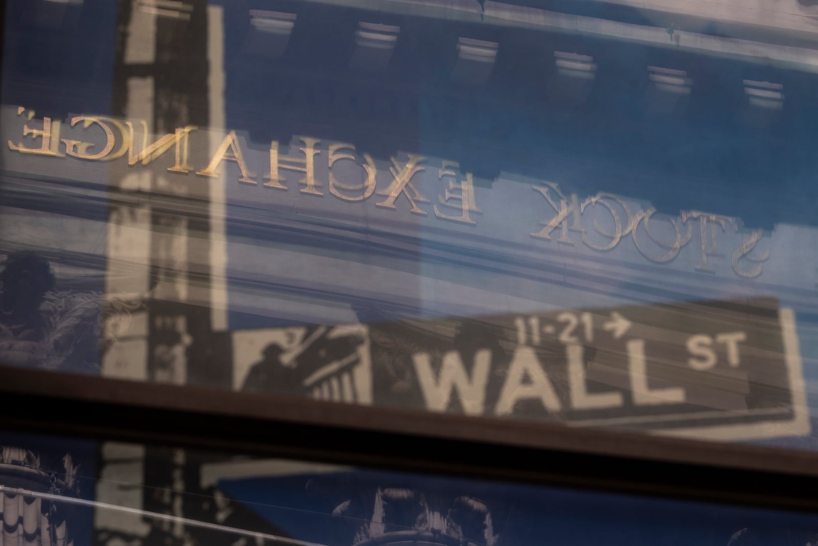 A reflection of a window shows the New York Stock Exchange on Monday, June 30, 2025, in New York. (AP Photo/Yuki Iwamura)
