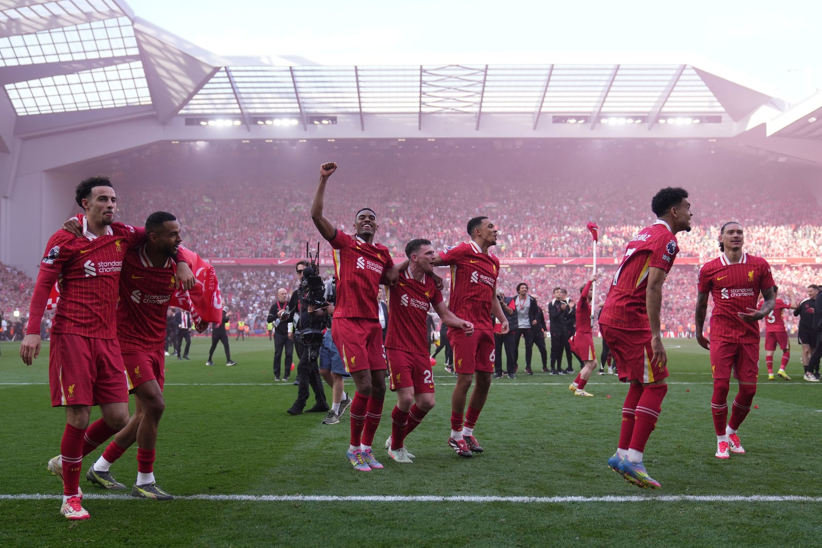 Liverpool players celebrate after winning the English Premier League soccer match between Liverpool and Tottenham Hotspur and clinching the Premier League title at Anfield in Liverpool, England, Sunday, April 27, 2025. (AP Photo/Jon Super)