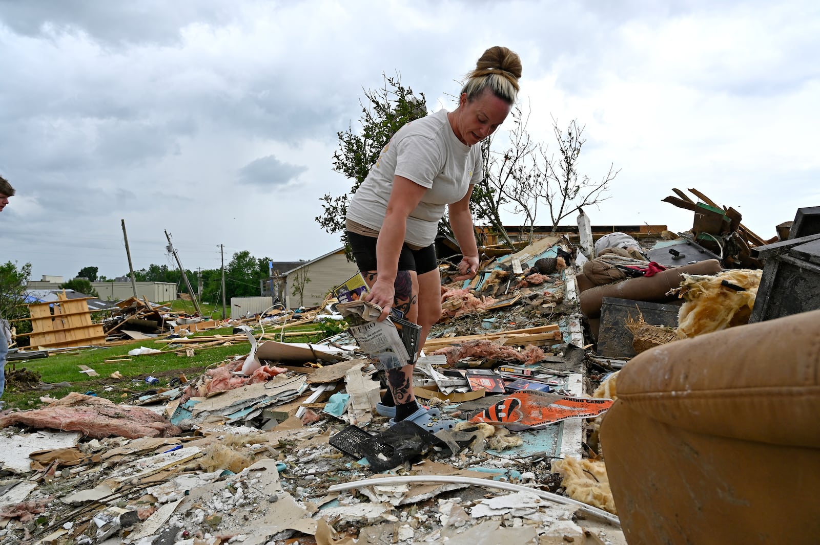 Angela Lewis goes through the remains of a house that was destroyed by severe weather in the Sunshine Hills neighborhood in London, Ky., Monday, May 19, 2025. (AP Photo/Timothy D. Easley)