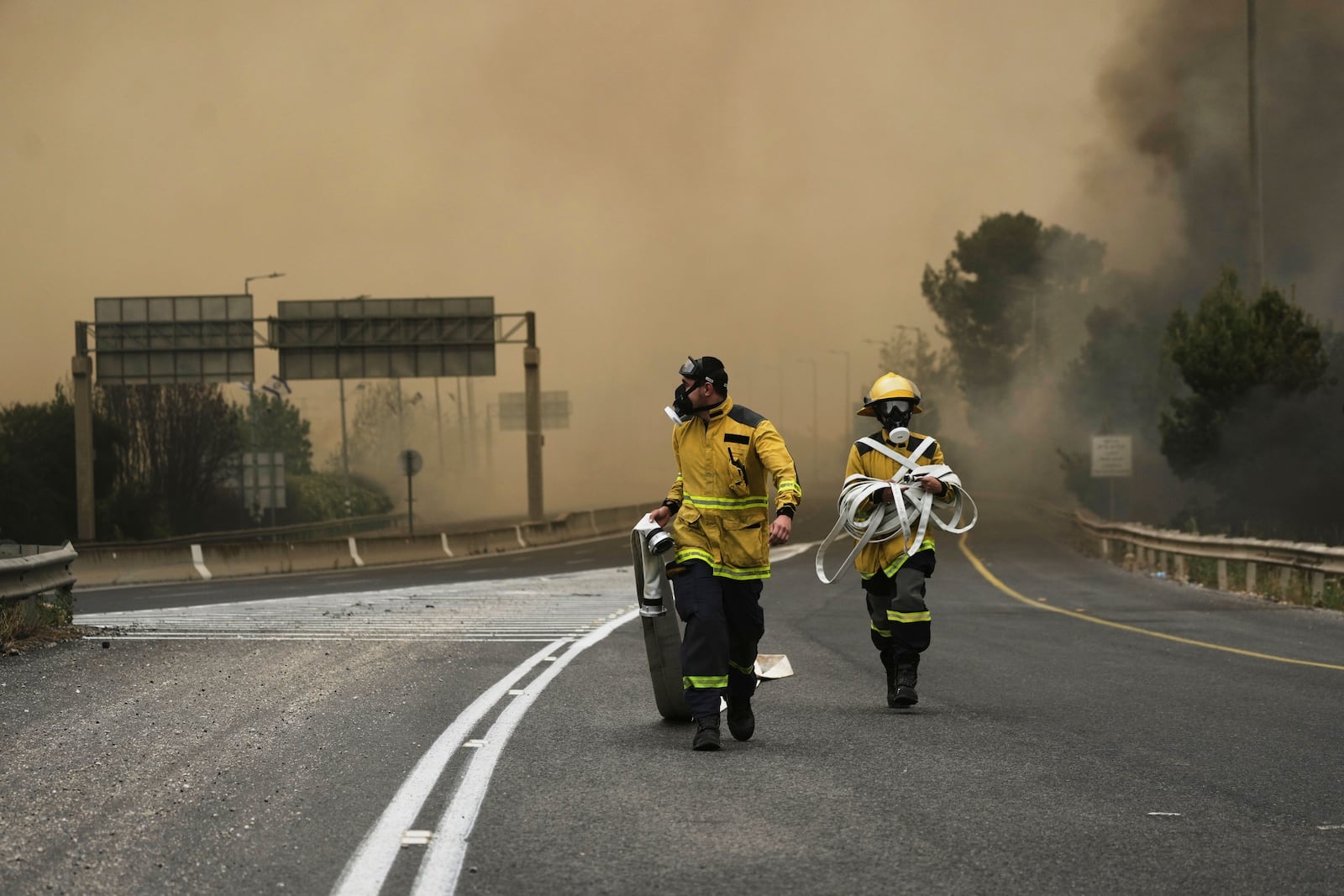 Israeli firefighters work to extinguish a forest fire burning near Jerusalem, Wednesday, April 30, 2025. (AP Photo/Mahmoud Illean)