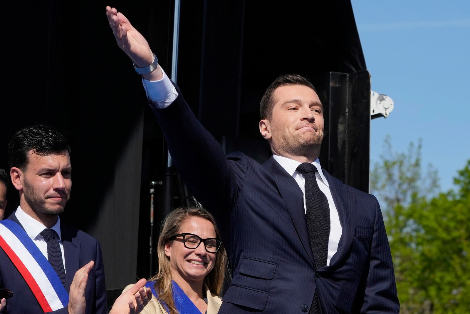 The leader of France's National Rally (RN) Jordan Bardella arrives as he attends at the French far-right party national rally near the parliament in support of Marine Le Pen in Paris, Sunday, April 6, 2025. (AP Photo/Michel Euler)