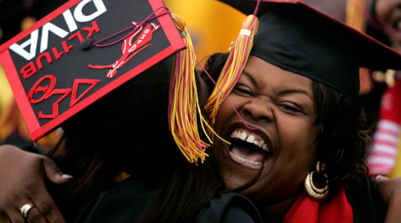 A Central State University graduate gets a hug from a fellow student at the commencement ceremony held at the university Saturday, May 3, 2008.