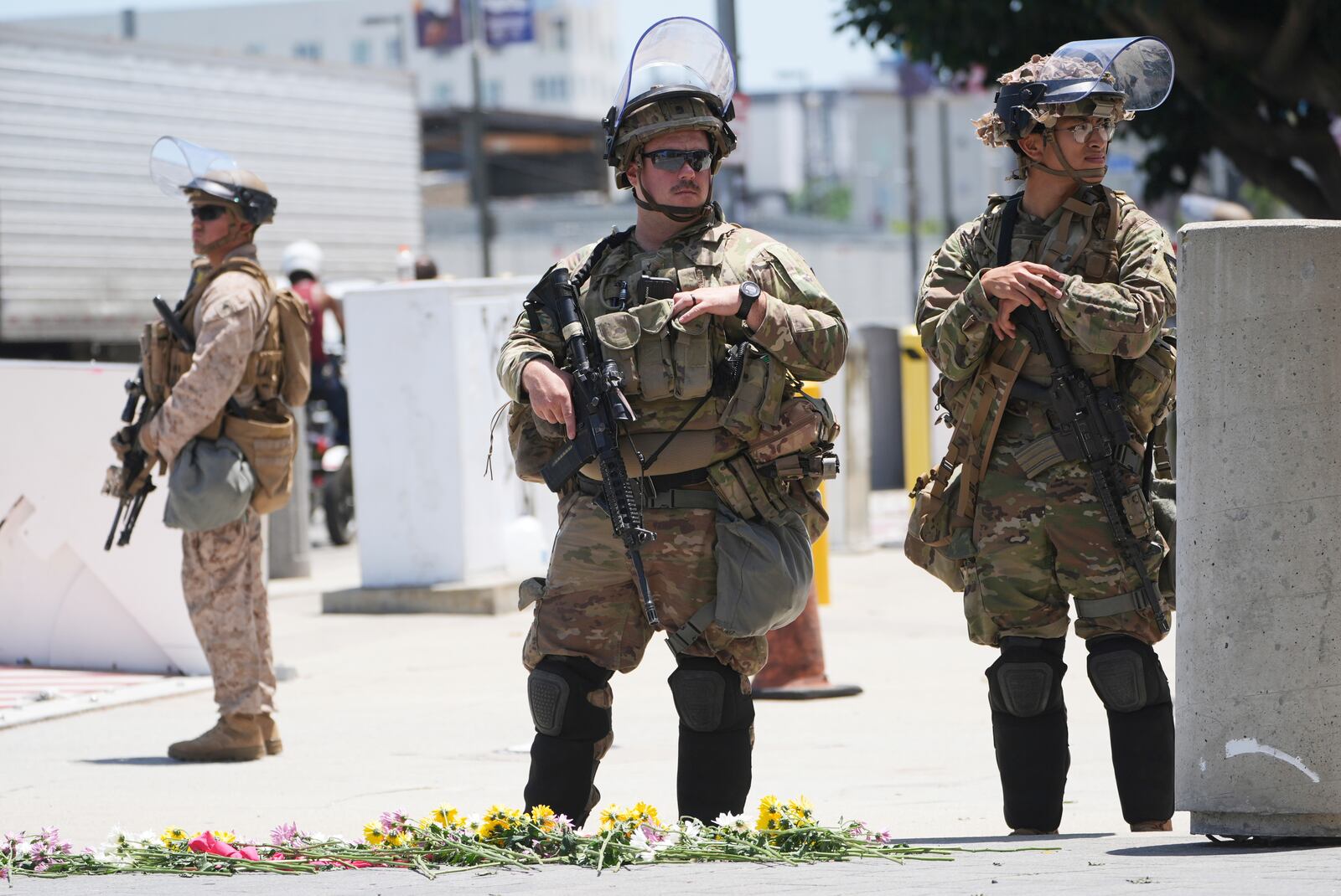 Members of the California National Guard and U.S. Marines guard a federal building on Tuesday, June 17, 2025, in Los Angeles. (AP Photo/Damian Dovarganes)