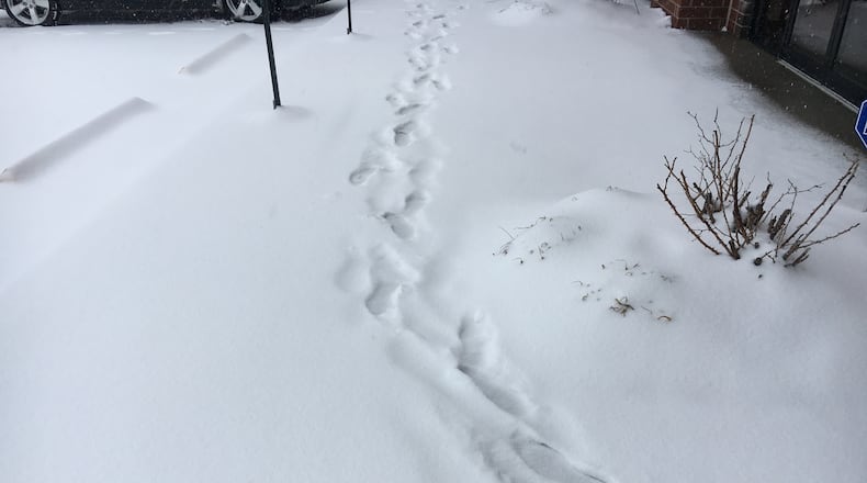 The snow is beginning to pile up, and Cincinnati Dayton Road in Liberty Twp. was treacherous Saturday morning. STAFF
