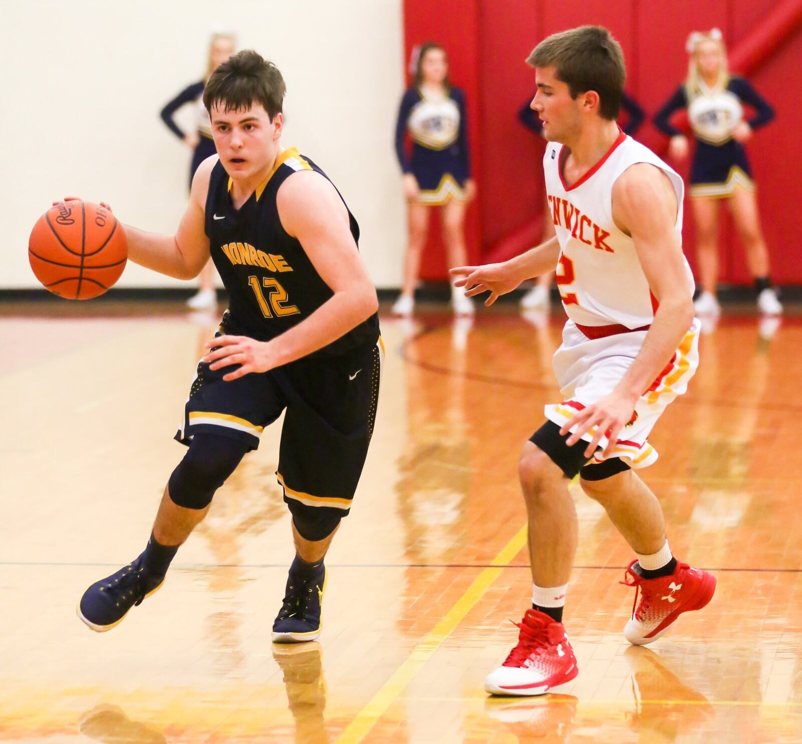 Monroe guard Nick Osterman (12) is defended by Paul Blodgett of Fenwick on Tuesday night at Fenwick. GREG LYNCH/STAFF