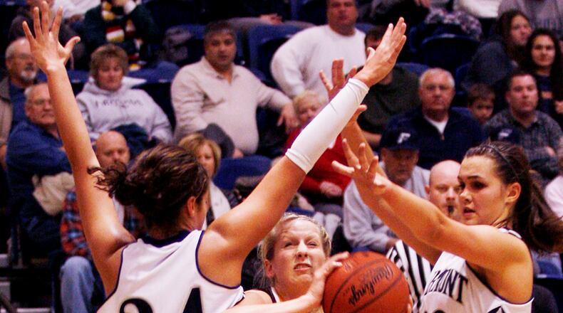 Alter’s Whitney Dabbelt sneaks through Fairmont’s MaKayla Waterman and Kathryn Westbeld for the basket at Fairmont High School’s Trent Arena in Kettering on Wednesday, Dec. 1.