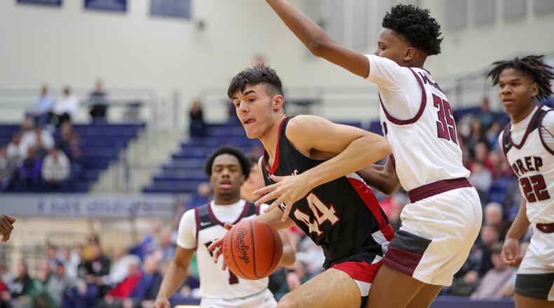 Preble Shawnee's Logan Hawley is pressured by a Harvest Prep defender during the Division III regional final game Saturday, March 11, 2023 at Trent Arena in Kettering. Preble Shawnee lost to Canal Winchester Harvest Prep 56-49. CONTRIBUTED PHOTO BY MICHAEL COOPER