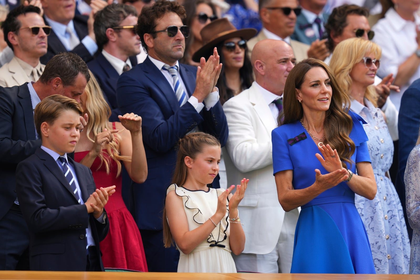 Britain's Kate, Princess of Wales, right, Prince George, left, and Princess Charlotte applaud as they watch Jannik Sinner of Italy and Carlos Alcaraz of Spain during their men's singles final match at the Wimbledon Tennis Championships in London, Sunday, July 13, 2025.(AP Photo/Kirsty Wigglesworth)