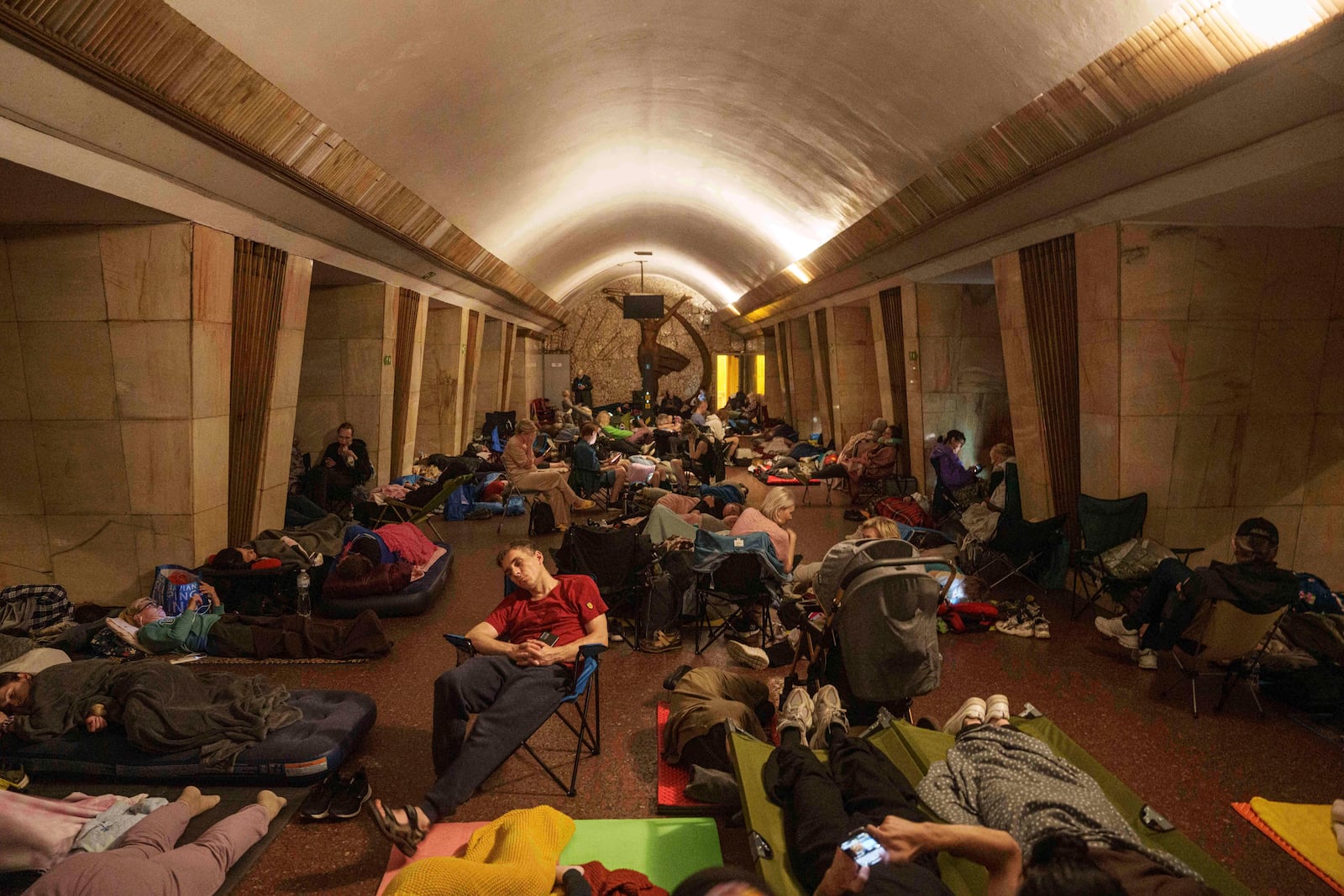 People sleep on the platform of a metro station as they take cover during a Russian attack on Kyiv, Ukraine, on Thursday, July 10, 2025. (AP Photo/Evgeniy Maloletka)