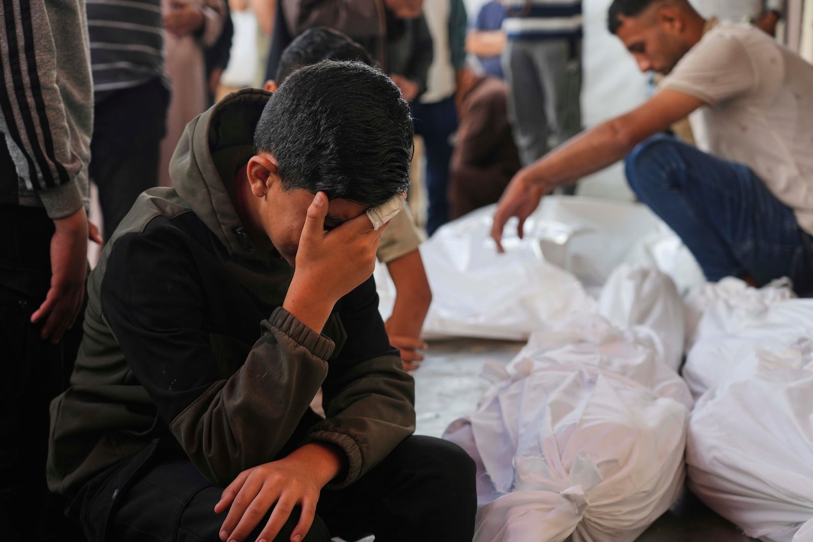Palestinians mourn their relatives who were killed in an Israeli army airstrike on the Gaza Strip, at the Al-Aqsa Hospital in Deir al-Balah, Gaza, Wednesday, May 28, 2025. (AP Photo/Abdel Kareem Hana)
