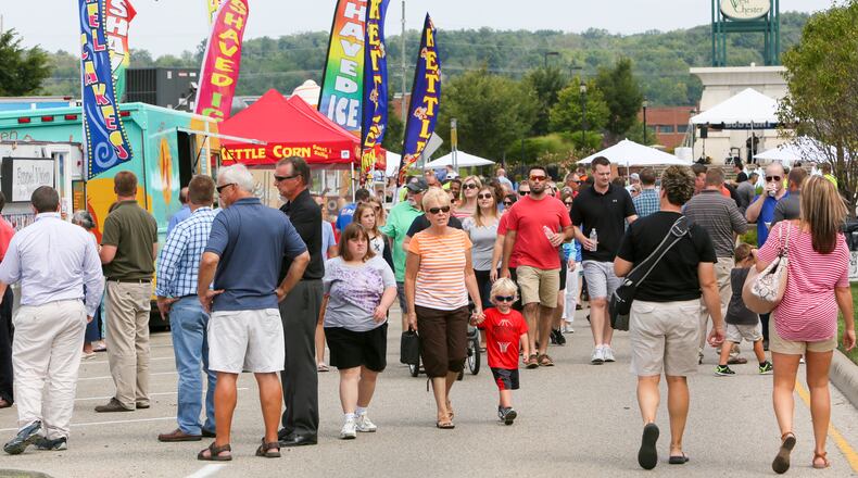 Hungry visitors walk past lines of food trucks during the Union Centre Food Truck Rally, Aug. 11, 2017, in West Chester Twp. GREG LYNCH / STAFF FILE PHOT