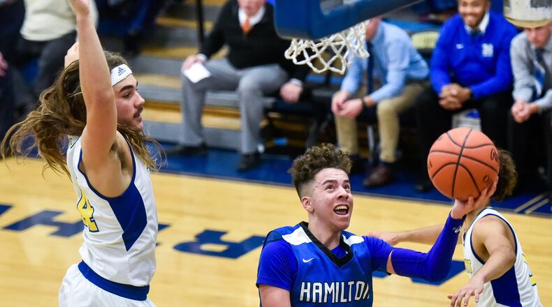Hamilton’s Jaylen Robinson drives to the hoop as he is defended by Northwest’s Diego Neri (24) during Friday night’s game in Colerain Township. HHS won 58-52. NICK GRAHAM/STAFF