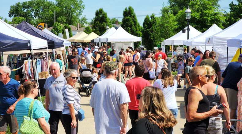 Visitors stroll through Hamilton Flea, a monthly urban artisan market, Saturday, May 14, 2022 at Marcum Park in Hamilton. NICK GRAHAM/STAFF