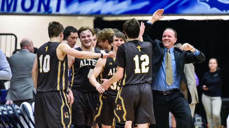 The Alter Knights react after beating Badin 60-51 in a Division II sectional final Tuesday night at Fairmont’s Trent Arena. NICK GRAHAM/STAFF