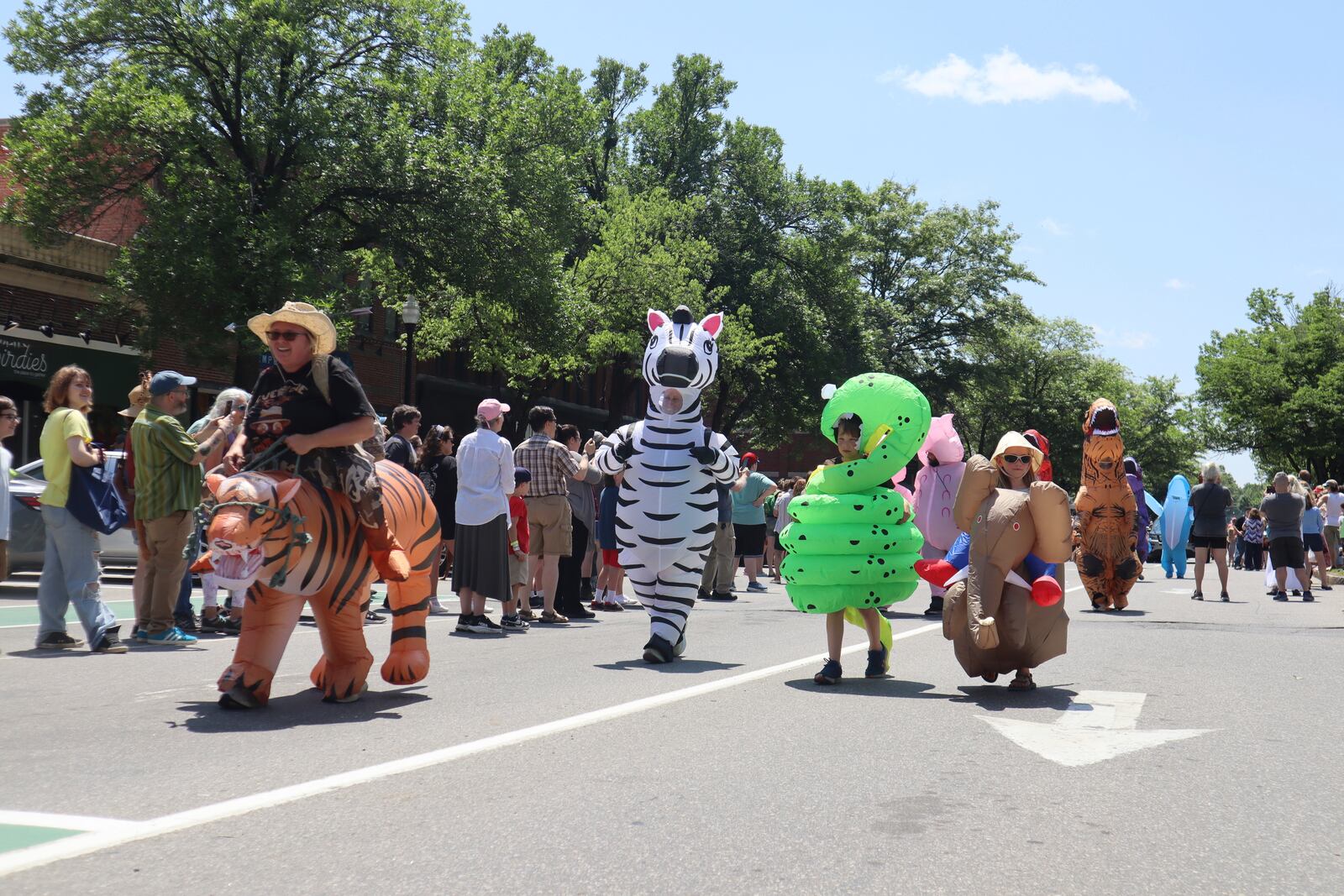 Crowds dressed in inflatable costumes participate in the 'Rhino Rumble Road Race' to celebrate the 30th anniversary of the film 'Jumanji' in downtown Keene, N.H. on Saturday, June 21, 2025. (AP Photo/Leah Willingham)