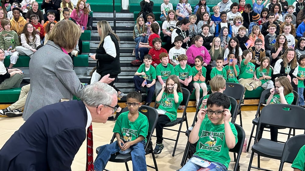 Gov. Mike DeWine and First Lady Fran check on some kindergarten and first-grade New Miami students who received free glasses Thursday afternoon as part of the Ohio Student Eye Exam program. RICK McCRABB/CONTRIBUTOR