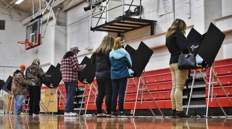 Voters cast their ballot on Election Day Tuesday, Nov. 3, 2020, in the auxiliary gymnasium at Madison Schools in Madison Twp, Butler County. Individuals from Butler County were among 75 referred by the secretary of state to the Ohio attorney general for allegedly voting in another state before casting a ballot in Ohio for the 2020 presidential election. NICK GRAHAM / STAFF
