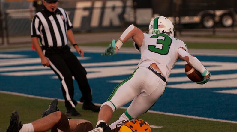 Badin receiver Lucas Moore is stopped at the 1-yard line by Alter's Mike Lantz at the end of a 39-yard catch to set up the Rams' first touchdown in Friday night's 14-12 victory over Alter at Roush Stadium. Jeff Gilbert/CONTRIBUTED