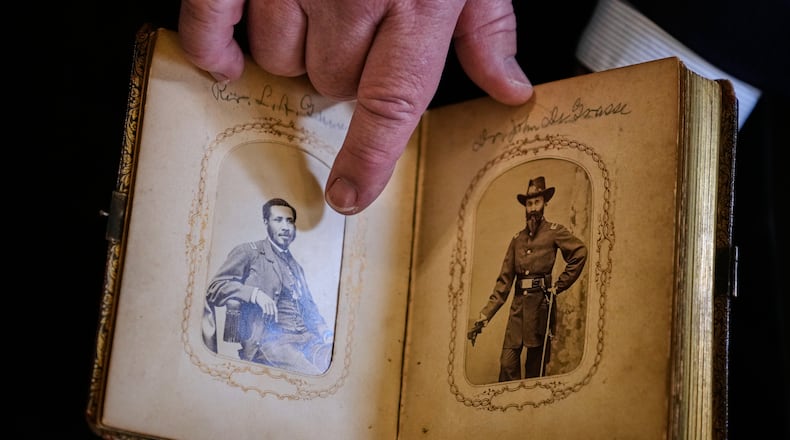 Portraits of Mass. Rep. Charles Lewis Mitchell, left, and Dr. John V. de Grasse are shown from an photograph album from the personal collection of anti-slavery activist Harriet Hayden, which was printed in the 1860's, at the Boston Athenaeum, Thursday, Oct. 9, 2025, in Boston. (AP Photo/Charles Krupa)
