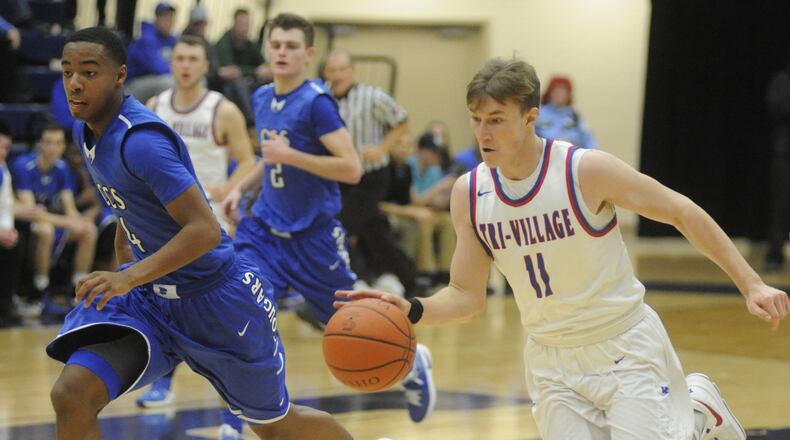 Gavin Richards of Tri-Village (with ball) and defender Dylan Woods. Cincinnati Christian defeated Tri-Village 49-42 in a boys high school basketball D-IV regional semifinal at Fairmont’s Trent Arena. Richards was named second team All-Ohio and Woods third team by the Associated Press on Monday. MARC PENDLETON / STAFF
