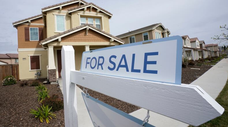 FILE - A For Sale sign is posted in front of a home in Sacramento, Calif., Thursday, March 3, 2022. California's unemployment rate has fallen to 4.3% adding 42,900 jobs in May. But the jobs report released by California Employment Development Department, Friday, June 17, 2022 is overshadowed by recent signs of a wobbly economy. Inflation is at a 40-year high and the monthly average interest rates on a 30-year fixed mortgage surpassed 5% for the first time since April 2010, resulting in 9.8% fewer homes sold in May compared to April.(AP Photo/Rich Pedroncelli, File)