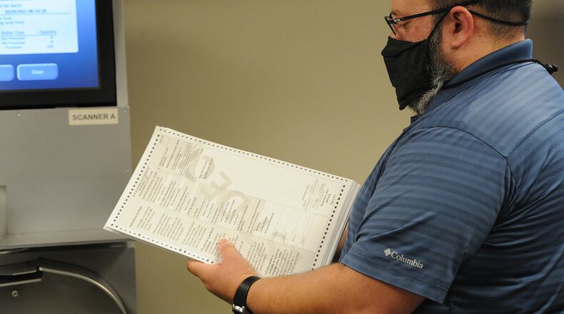 Adam Lawson, Infrastructure Engineer for the Montgomery County Board of Elections, prepares to insert test ballots for the public test of the election equipment and system that will be used for the November 2, 2021 general election. MASHALL GORBY\STAFF