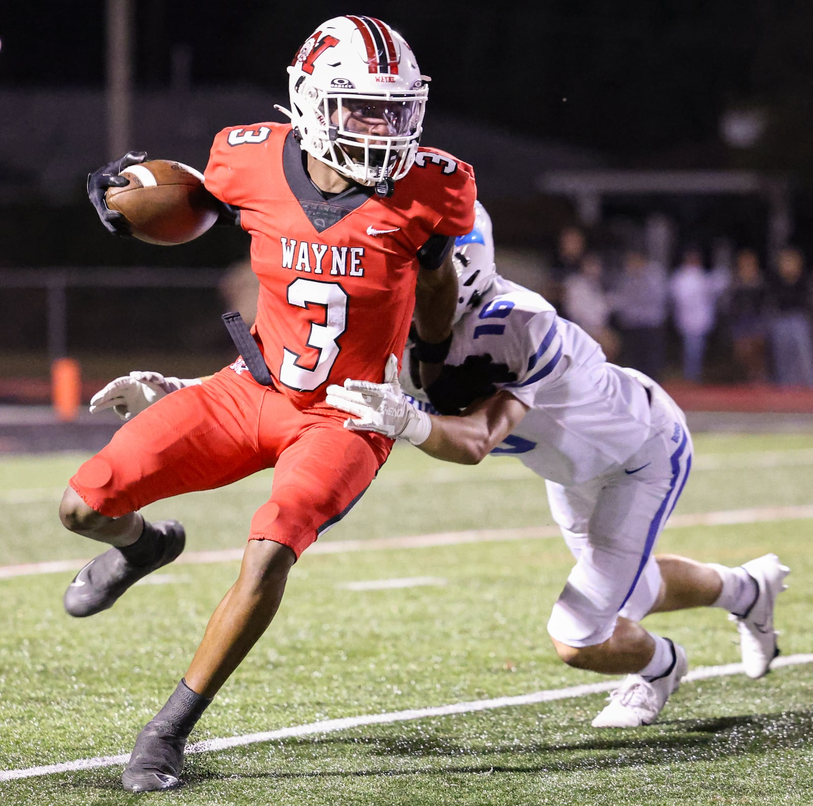 Wayne sophomore quarterback Kye Graham runs with pressure from Springboro's Cole Henson during a Greater Western Ohio Conference game on Friday, Sept. 12 at Heidkamp Stadium. BRYANT BILLING / STAFF