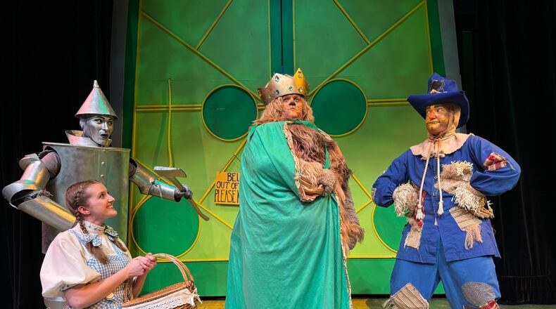 Allison Gabert (Dorothy) with Jonathan Pendergrass (Tin Man), Nate Marcum (Lion) and Dylan Jackson (Scarecrow) in La Comedia Dinner Theatre's production of "The Wizard of Oz." PHOTO BY  JUSTIN WALTON