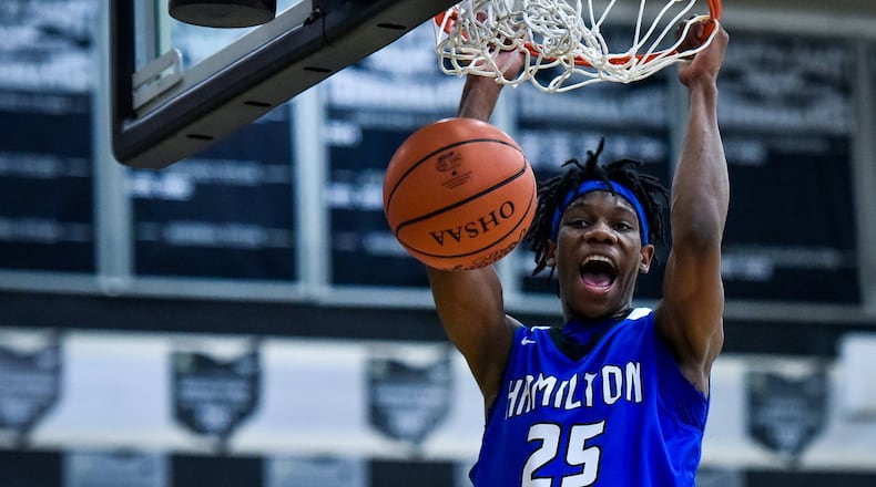 Hamilton’s D’Marco Howard shows some joy while dunking the ball Friday night at Lakota East. Visiting Big Blue won 65-62. NICK GRAHAM/STAFF