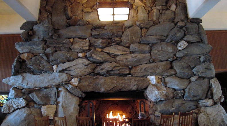 FILE - This Feb. 2, 2015 photo shows rocking chairs in front of the massive stone fireplace in the lobby of the Grove Park Inn in Asheville, N.C. (AP Photo/Beth J. Harpaz, File)