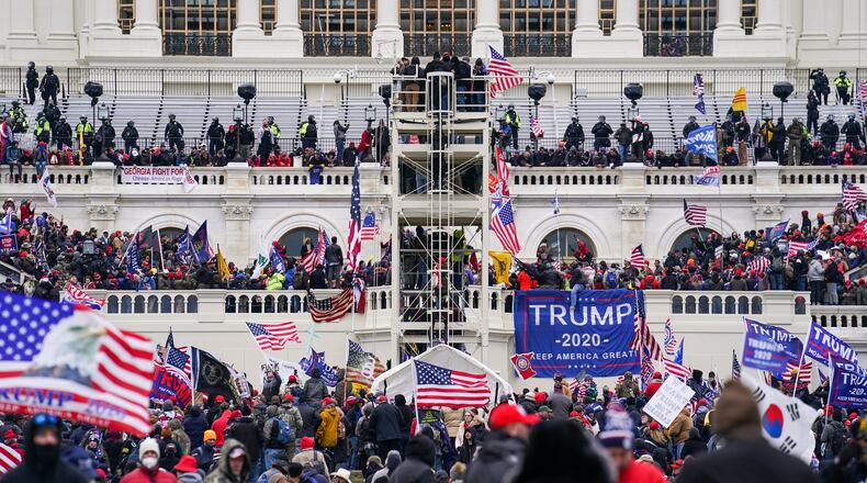 FILE - In this Jan. 6, 2021, file photo insurrectionists loyal to President Donald Trump breach the Capitol in Washington. Prosecutors secured the first guilty plea in the major case brought against members of the Oath Keepers extremist group in the attack on the U.S. Capitol, while an Indiana woman who became first person to be sentenced for the Jan. 6 riot avoided time behind bars.  (AP Photo/John Minchillo)