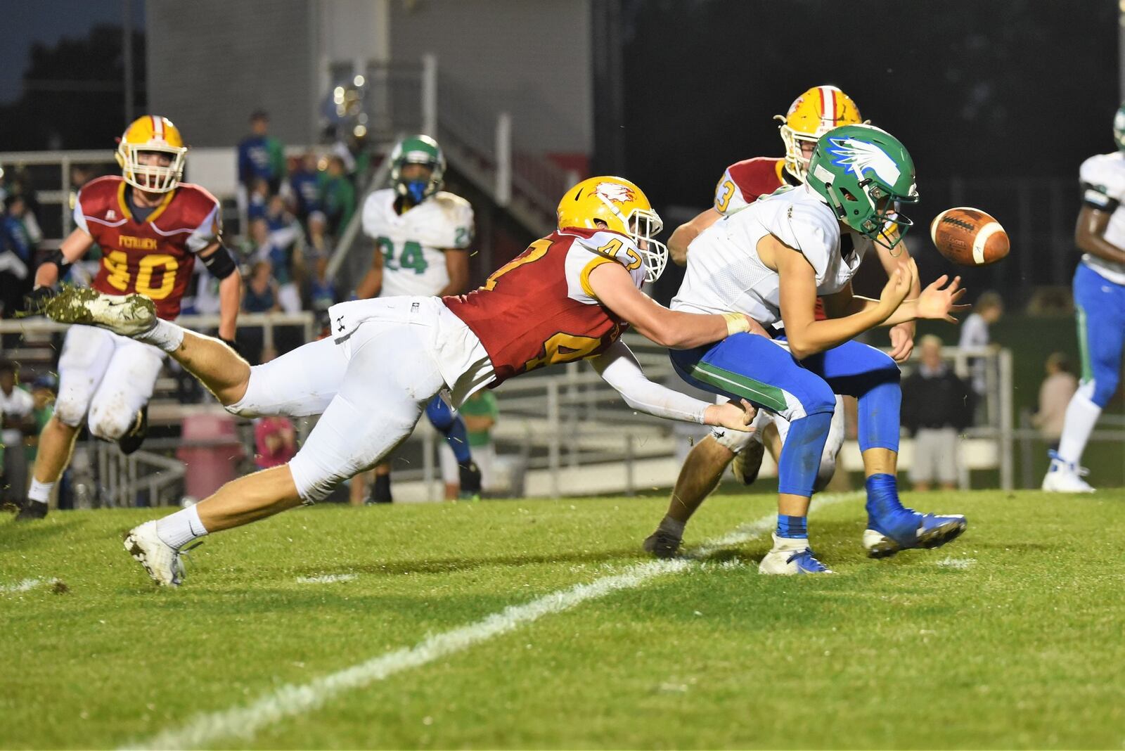 Fenwick’s Ben Gustely (47) and Joe Perrotti (43) apply the pressure as Chaminade Julienne quarterback Luke Chandler fumbles the ball during an Oct. 5 game at Krusling Field in Middletown. Fenwick posted a 34-19 win. CONTRIBUTED PHOTO BY ANGIE MOHRHAUS