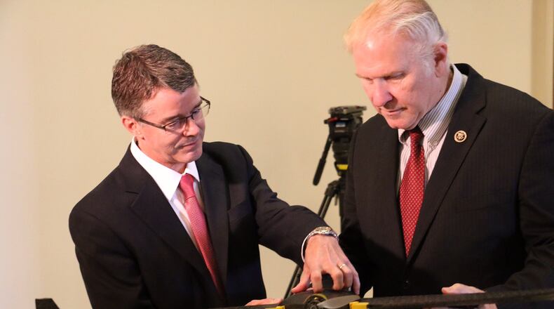 Mike Gilkey, left, owner of 3D Aerial in Dayton, shows a drone to U.S. Rep. Steve Chabot, R-Cincinnati, during Gilkey’s testimony this week before the U.S. House Committee on Small Business.