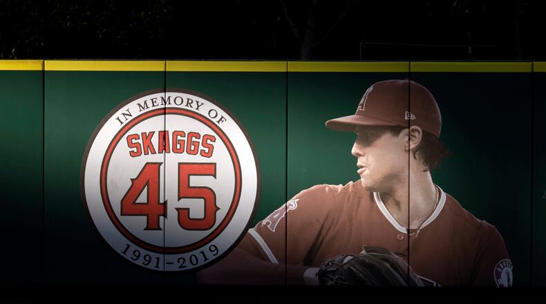 FILE - An image and logo memorializing former Los Angeles Angels pitcher Tyler Skaggs is displayed on the outfield wall in Anaheim, Calif., July 17, 2019. (AP Photo/Kyusung Gong, File)