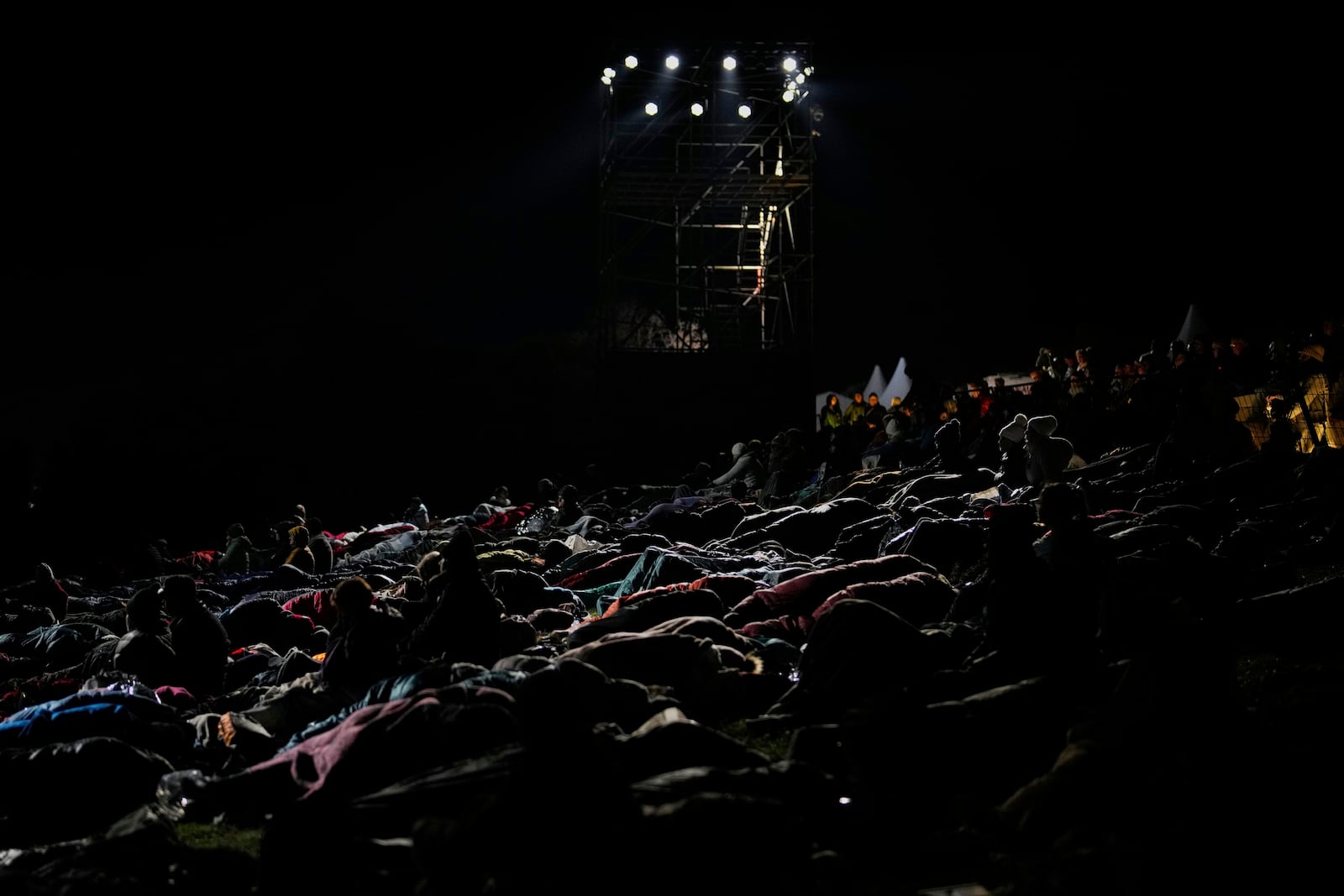 Attendees wait for the start of the "Spirit of Place" ceremony and dawn memorial service at the Anzac Cove beach, the site of the April 25, 1915, World War I landing of the ANZAC (Australian and New Zealand Army Corps) on the Gallipoli peninsula, near Canakkale, Turkey, early Friday, April 25, 2025. (AP Photo/Emrah Gurel)
