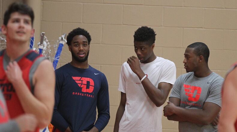 Josh Cunningham, left, talks to Kostas Antetokounmpo and Kendall Pollard during practice on Monday. Cunningham did not practice Monday because of an illness but was expected to practice Tuesday. David Jablonski/Staff
