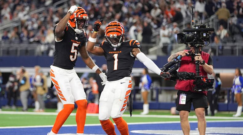 Cincinnati Bengals wide receiver Ja'Marr Chase (1) celebrates his touchdown with wide receiver Tee Higgins (5) during the second half of an NFL football game against the Dallas Cowboys, Monday, Dec. 9, 2024, in Arlington, Texas. The Cincinnati Bengals won 27-20. (AP Photo/Julio Cortez)