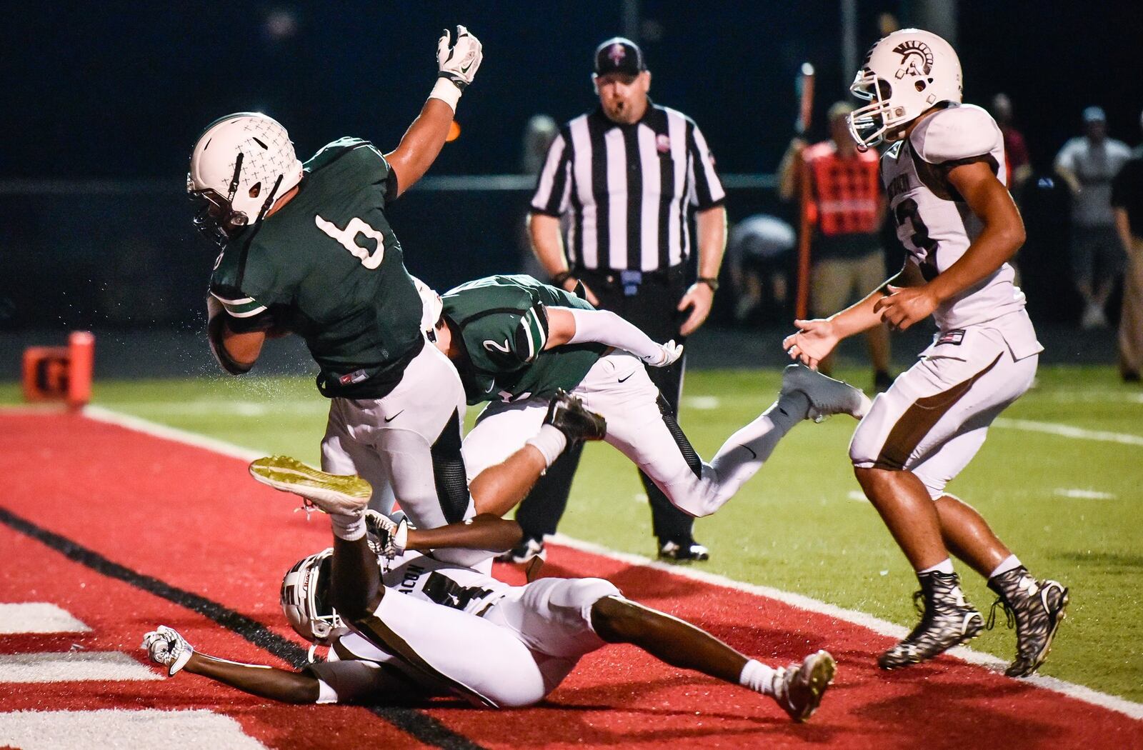 Badin’s Lavassa Martin carries the ball across the goal line for a touchdown against Roger Bacon on Sept. 22 at Fairfield Stadium. NICK GRAHAM/STAFF