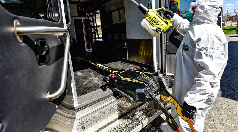 Hamilton firefighter paramedic Jason Bunger puts on his protective gear to demonstrate the decontamination process they are doing to medic units in response to the coronavirus (COVID-19) pandemic. They are using a fogger to coat the inside of the unit with disinfectant and wiping down the inside after ten minutes. NICK GRAHAM / STAFF