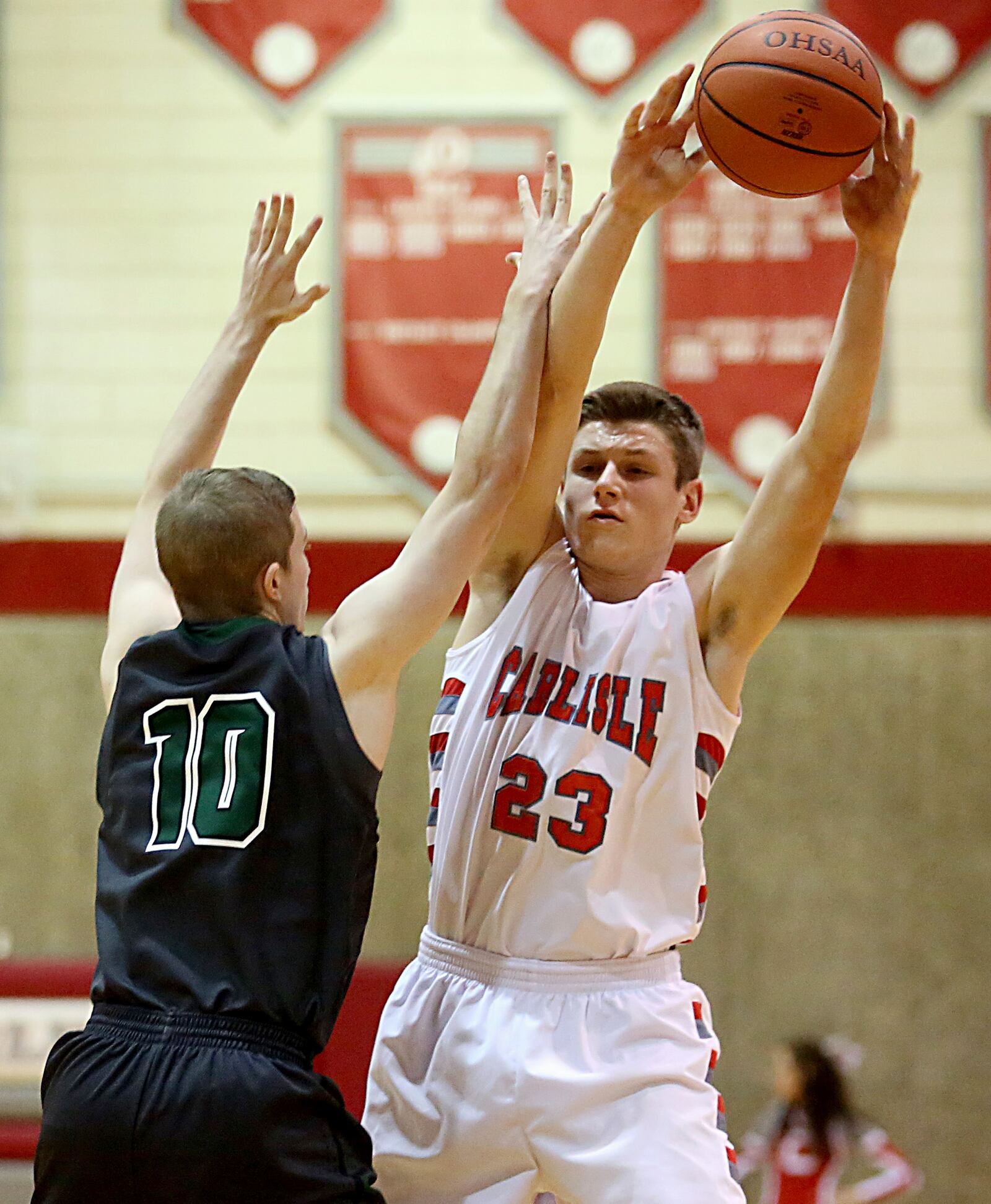 Carlisle forward Caleb Boy is covered by Badin wing Alex Jones on Saturday night at The Pit in Carlisle. CONTRIBUTED PHOTO BY E.L. HUBBARD
