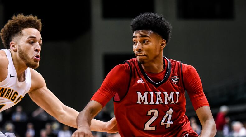 Miami University’s Michael Weathers dribbles to the hoop defended by Wright State’s Justin Mitchell during their 89-87 loss to Wright State University Tuesday, Nov. 15 at Wright State University’s Nutter Center in Fairborn. NICK GRAHAM/STAFF