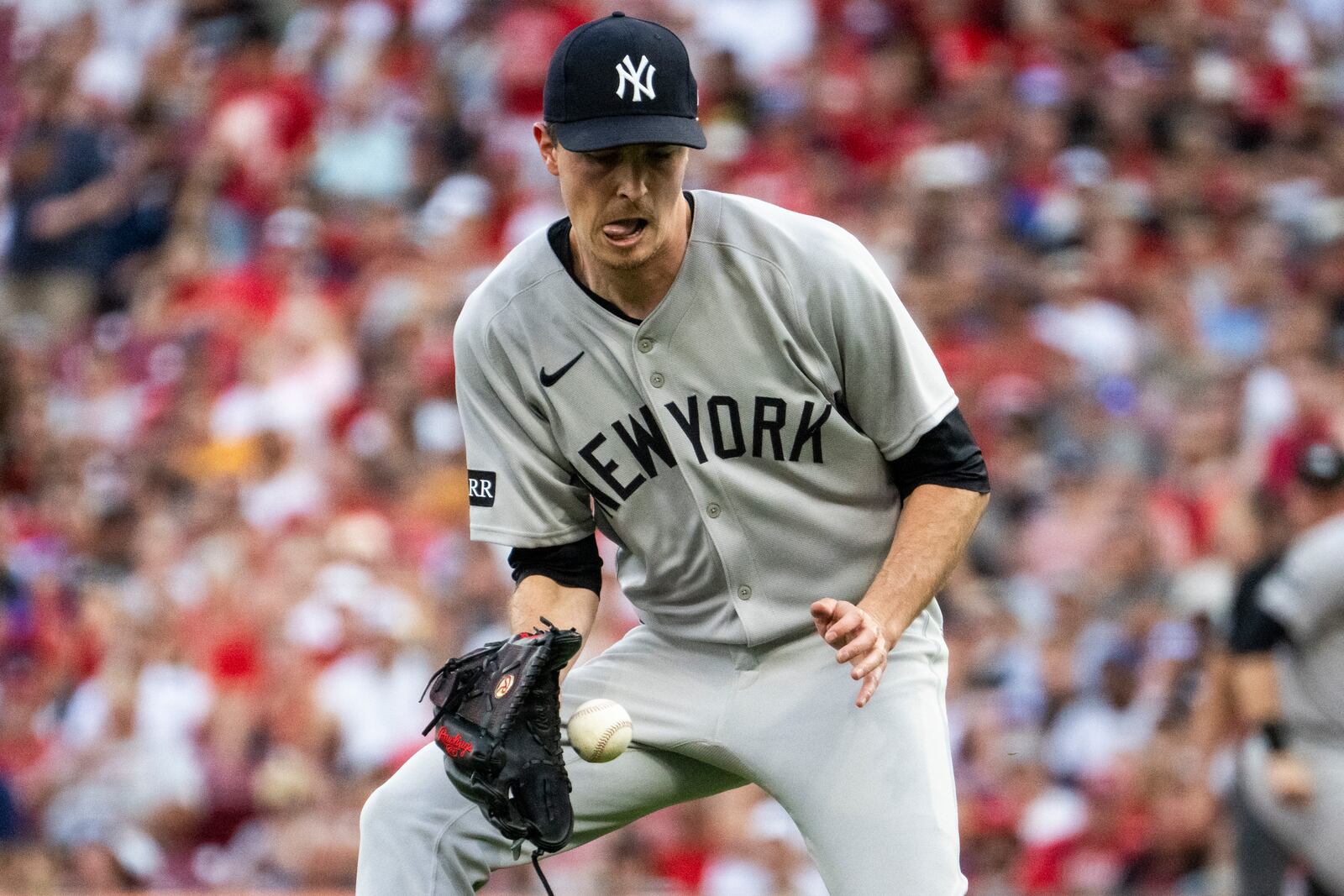 New York Yankees pitcher Max Fried catches a bouncing ball and throws to first base for an out in the third inning of a baseball game against the Cincinnati Reds, Wednesday, June 25, 2025, in Cincinnati. (AP Photo/Michael Swensen)