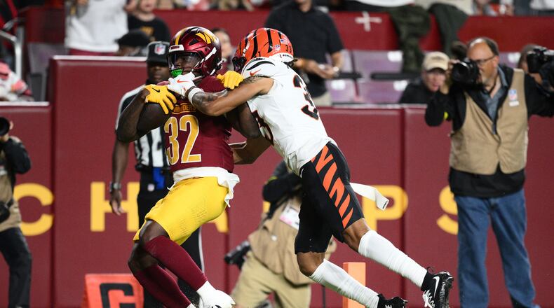 Washington Commanders running back Jacory Croskey-Merritt (32) scores past Cincinnati Bengals safety Daijahn Anthony during the first half of a preseason NFL football game Monday, Aug. 18, 2025, in Landover, Md. (AP Photo/Nick Wass)