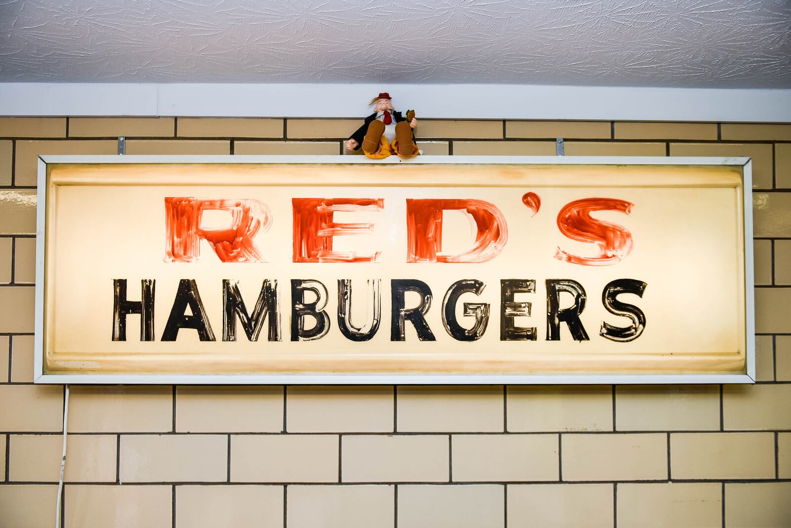Red's Hamburger Shop at 103 S. Riverside Drive in New Miami is reopening next month under new owners. The old sign is now on display on the wall in the dining area. NICK GRAHAM/STAFF