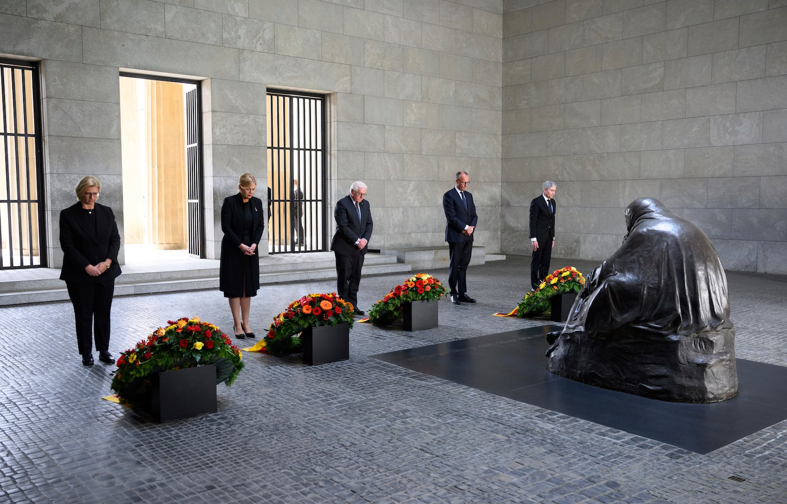 German Federal President Frank-Walter Steinmeier, center, lays a wreath at the Neue Wache, the Federal Republic of Germany's central memorial to the victims of war and tyranny, with representatives of the federal constitutional bodies from left, Anke Rehlinger, Minister-President of Saarland and current President of the Bundesrat, Bundestag President Julia Klöckner, Federal Chancellor Friedrich Merz, and Stephan Harbarth, President of the Federal Constitutional Court, in Berlin, Thursday, May 8, 2025, on the 80th anniversay the Second World War in Europe came to an end. (Bernd von Jutrczenka/dpa via AP)